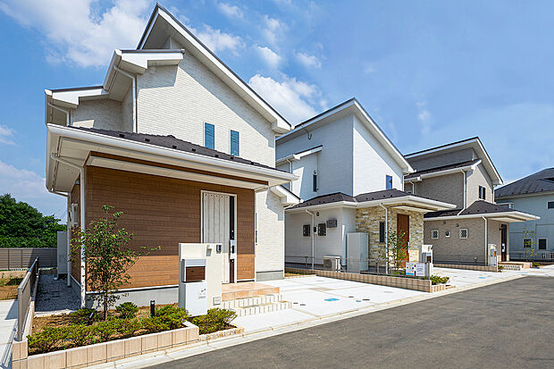 【【 住協建設の施工例 】】青空に映える、白と木目のコントラスト。 素材感のある木目調パネルがアクセントに。明るく開放感あふれるデザインが、日々の暮らしを軽やかに彩ります。