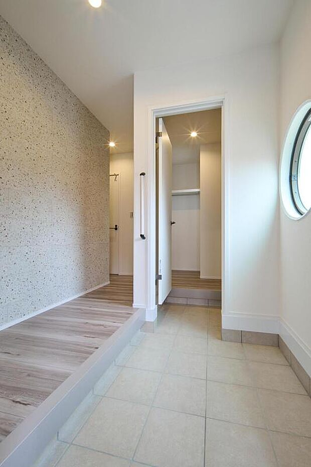 【【施工例】】土間収納を備えた玄関です。土間収納はウォークスルータイプで、家族と来客の動線を分けることができます。土間収納を抜けるとファミリークロークがあり、上着などを掛けておくことができます。