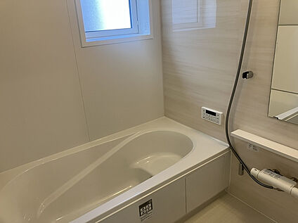 白を基調とした清潔感のある浴室で、ゆったりとしたバスタイムを