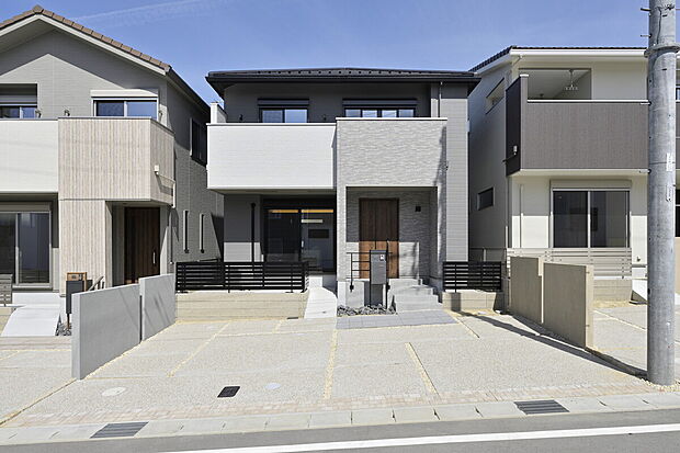 【【B-9棟 外観】】周辺の街並みと調和する、お洒落な外観デザイン。アースカラーの優しい色合いが青空に映えます。全棟長期優良住宅認定物件です。