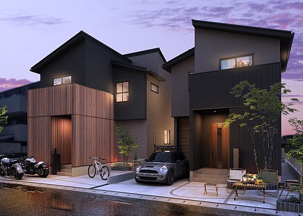 深みのあるブラック外壁にウッド調の質感が映えるスタイリッシュな2邸。エクステリアライトが陰影をつくり、モダンでシャープな佇まいを際立たせます。（街並完成予想図）