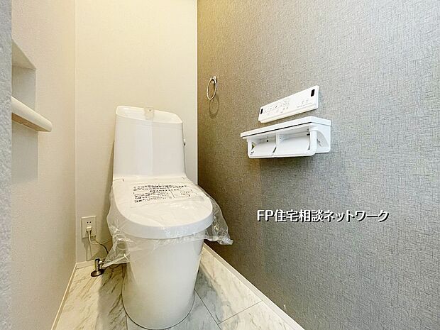 【トイレ】落ち着いたグレーのアクセントクロスが上質な雰囲気を演出。手洗い一体型で使い勝手も良好。清潔感あふれる明るいトイレ空間です。