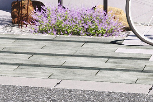 【雨の日も快適な透水性舗装材】カースペース部分に自然の風合いとあたたかみを持つ舗装材を採用。日常の中に豊かな交流が生まれる場をつくりました。