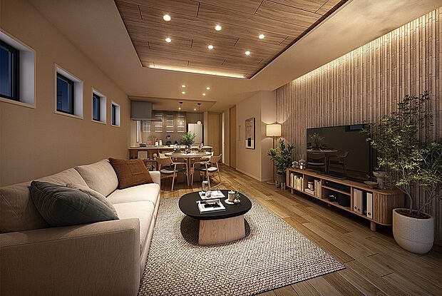 家族との繋がりを感じながらくつろげる一体感のあるLDK。空間に変化を添えるアクセントウォールや、柔らかな灯りでリビングを彩る間接照明が、家族との時間を優しく包み込みます。（1号棟内観完成予想図）