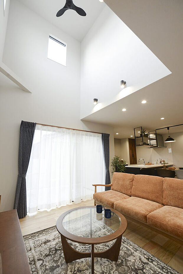 【21帖のLDK】解放感ある吹き抜け、ワイドサイズの掃き出し窓で明るいリビング。 ブラックのアイアンでヴィンテージ感を演出した落ち着く空間です。