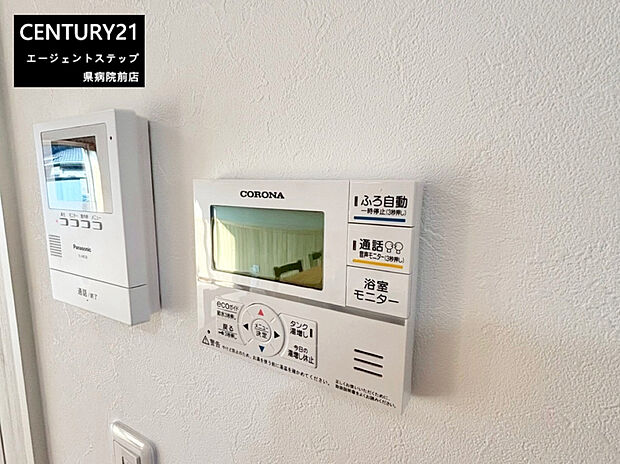 【浴室モニター】壁に設置された浴室モニターとインターホンが目を引く一枚です。浴室モニターは操作性が高く使いやすいデザインです。インターホンもシンプルで来客時の確認に便利です。どちらも生活をサポートする設備です。