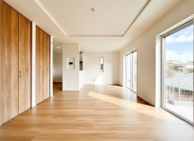 【リビング】ナチュラルな木目調のフローリングと白壁のコントラストが美しく、どんな家具とも相性の良い洗練された内装が魅力です 。家族の会話も弾む、明るく健やかな暮らしを叶えるリビングです。