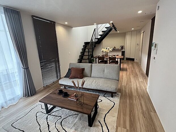 大きな窓から光が差し込むおしゃれなLDK。開放感があり、家族が心地よく過ごせる空間です。