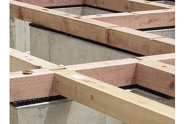 【剛性・耐久性にすぐれた「ベタ基礎」】コンクリートで建物の下一面を支える工法。　基礎鉄筋を張り、強度を高めたベタ基礎の耐圧盤を1階の床下全面に施工し、広い耐圧盤の面で建物の荷重を地盤に伝えます。
