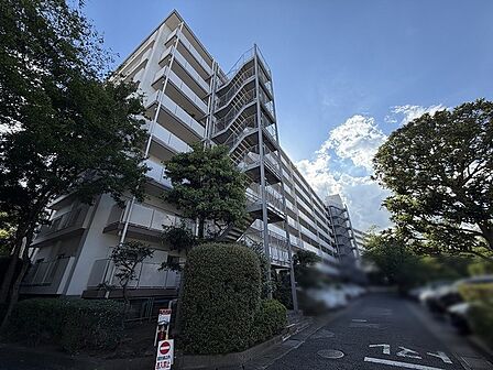 青空の下、豊かな植栽と調和しながら穏やかな時間が流れる住環境がここにあります。