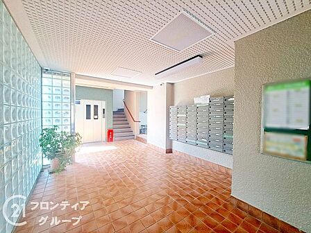 外からの明るい自然光がたっぷりと差し込む広々とした心地よいロビー空間です 美しく敷き詰められた床面と整然とした郵便受けが整い毎日の暮らしを気持ちよく支えてくれます