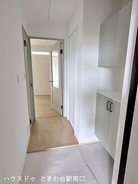 明るい木目調フローリングと淡いグリーンの建具が調和した、清潔感あふれる心地よい玄関・廊下空間です。