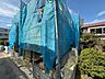 外観：青い養生シートで覆われた建物の外観