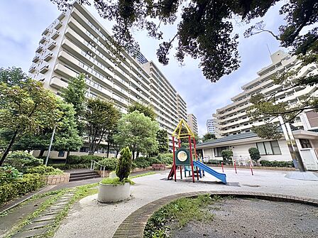 緑地と歩道に囲まれた集合住宅の外観