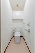1階の清潔感のあるトイレです。上部に棚が付いているので、トイレットペーパーなどがスッキリと片付きます。