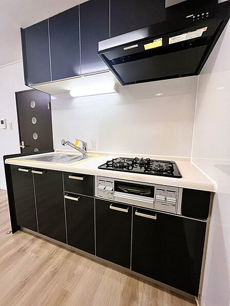 壁付のキッチンは上部に収納が作りやすいのがメリット。空間を有効活用したすっきりとしたデザイン。