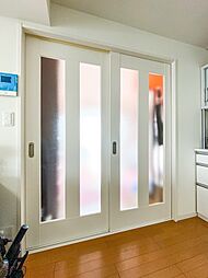 [居間] 洋室1の引き戸はDKに明かりを取り込む扉が採用されています。